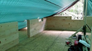 tarp covering logs from weather, log home construction site, pre-cut logs, laminated, kiln dried, Timberhaven, custom built log home, home builder