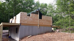 log home under construction, pre-cut logs, laminated, kiln dried, Timberhaven, custom built log home, home builder