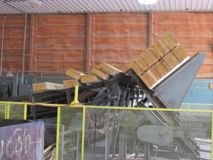 laminated logs being loaded onto conveyor, Timberhaven, custom built log home, log homes, log cabin, kiln-dried