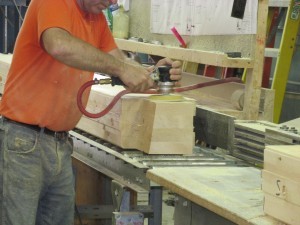 laminated log being sanded, Timberhaven Log Homes, custom built log home, kiln-dried