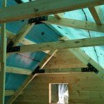 trusses being bolted together with gusset plates, log home construction, Timberhaven, custom built log homes, kiln dried, laminated