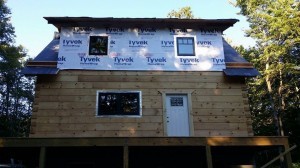 conventionally framed shed dormer with house wrap, log home construction progress, Timberhaven, custom built log home, laminated, kiln dried