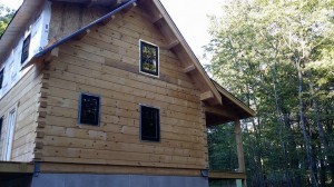 side and rear of log hoome under construction, log home construction progress, Timberhaven, custom built log home, laminated, kiln dried