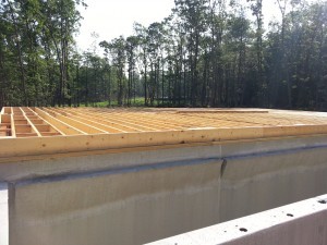 subfloor on pre-cast walls, post and beam construction, under construction, log homes, log cabins, log cabin kits, Timberhaven, post and beam cabin, post and beam cabin kits, kiln dried, laminated