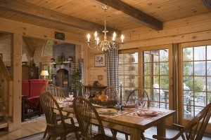 log home dining room with beautifully stained beams and tongue and groove, Timberhaven Log Homes, log home, log cabins, log cabin kits, post and beam homes, under construction, kiln dried, laminated