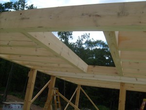 heavy timber loft joists in place and cut out for stair placement, post and beam construction, under construction, log homes, log cabins, log cabin kits, Timberhaven, post and beam cabin, post and beam cabin kits, kiln dried, laminated