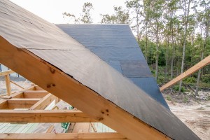 felt paper covering tongue and groove on ceiling of post and beam roof, post and beam homes, Timberhaven Log Homes, log home, log cabins, log cabin kits, post and beam homes, under construction, kiln dried, laminated