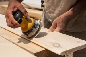 builder sanding tongue and groove, Timberhaven Log Homes, log home, log cabins, log cabin kits, post and beam homes, under construction, kiln dried, laminated