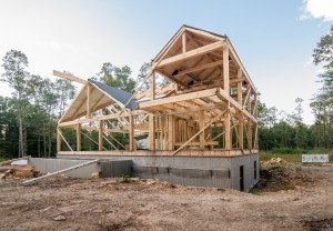 construction site of post and beam home with roof, Timberhaven Log Homes, log home, log cabins, log cabin kits, post and beam homes, under construction, kiln dried, laminated