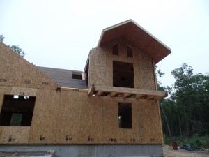 two-story post and beam home, roof SIPs being installed on custom post and beam home construction, post and beam homes, post and beam home design, Timberhaven Log Homes, log homes, log home, log cabins, log cabin kits, laminated, kiln dried, under construction