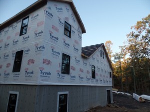 house wrap and window installation on post and beam home under construction, post and beam wood home, custom design, dream home, log homes, log cabin homes, log cabin kits, log cabins, Timberhaven Log Homes, laminated, kiln dried