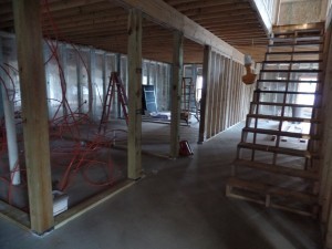 stairs to basement and interior wall framing, two-story home, post and beam house, laminated logs, heavy timbers, Timberhaven, log homes, log cabin kits, kiln dried