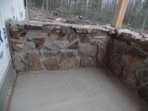 solid wall with real mountain stone, post and beam custom home, under construction, Timberhaven, log homes, log cabins, log cabin kits, contemporary siding, black standing seam metal, stone accents on home, laminated, kiln dried, custom post and beam home