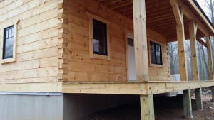 front porch of small log cabin, log cabin, log cabin homes, log homes, log cabin kits, Timberhaven, under construction, post and beam, laminated, kiln dried, PA manufacturer