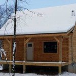 small log cabin covered with snow in the woods, log cabin, log cabin homes, log homes, log cabin kits, Timberhaven, under construction, post and beam, laminated, kiln dried, PA manufacturer