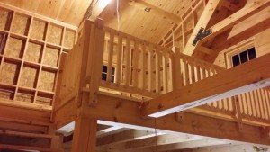 white pine railing on 2nd floor loft, log cabin, log homes, log cabin homes, Timberhaven, under construction, laminated, kiln dried, Pennsylvania manufacturer