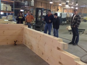 group looking at laminated log assembly, laminated logs, kiln dried, quality, Timberhaven, log homes, log cabins, log cabin kits, Pennsylvania log homes