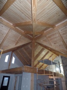 wide open space in main living area and loft, beam and purlin roof system, post and beam, custom home, log homes, log cabins, log cabin kits, Timberhaven, laminated, kiln dried, under construction, PA log home producer, dry wall installation