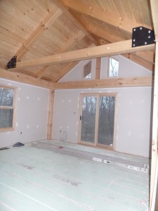 master bedroom with vaulted ceiling and private balcony, post and beam, custom home, log homes, log cabins, log cabin kits, Timberhaven, laminated, kiln dried, under construction, PA log home producer, dry wall installation