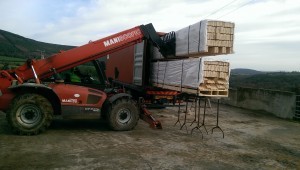 log home contens being unloaded in Ireland with Boom, Timberhaven Log Homes, log homes, log cabin homes, log cabins, post and beam homes, timberframe homes, timber frame homes, laminated logs, engineered logs, floor plan designs, kiln dried logs, international distribution