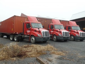 international sea containers lined up and ready to be loaded, Timberhaven Log Homes, log homes, log cabin homes, log cabins, post and beam homes, timberframe homes, timber frame homes, laminated logs, engineered logs, floor plan designs, kiln dried logs, international distribution