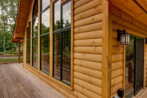 beautiful trim corner with vast wall of glass on log home, Timberhaven Log Homes, log homes, log cabins, log cabin homes, laminated logs, kiln dried logs, engineered logs, kiln-dried laminated logs, post and beam home, timber frame, Pennsylvania