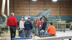 guests at builder's workshop seeing the planer at work, log home builders, Timberhaven Log Homes, log homes, log cabin homes, log cabins, post and beam homes, timberframe homes, timber frame homes, laminated logs, engineered logs, floor plan designs, kiln dried logs627_resized