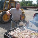 Randy grilling BBQ chicken on nice summer day, employee spotlight, Randy Beachel, Timberhaven Log Homes, log homes, log cabin homes, log cabins, post and beam homes, timberframe homes, timber frame homes, laminated logs, engineered logs, floor plan designs, kiln dried logs