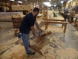 using chain saw to cut Dovetail corner, Timberhaven Log Homes, log homes, log cabin homes, log cabins, post and beam homes, timberframe homes, timber frame homes, laminated logs, engineered logs, floor plan designs, kiln dried logs, nature friendly