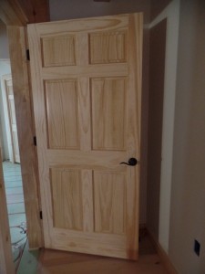 White Pine solid raised-panel interior doors, Schagle hardware in black, Timberhaven Log Homes, log homes, log cabin homes, log cabins, post and beam homes, timberframe homes, timber frame homes, laminated logs, engineered logs, floor plan designs, kiln dried logs