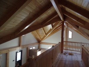 Loft overlooking main living area, White Pine railing, Hickory hardwood flooring, drywall painted white, post and beam home, interior finishes, Timberhaven Log Homes, log homes, log cabin homes, log cabins, post and beam homes, timberframe homes, timber frame homes, laminated logs, engineered logs, floor plan designs, kiln dried logs