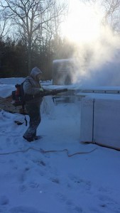 builder blowing snow off of a lock pack, Timberhaven Log Homes, log homes, log cabin homes, log cabins, post and beam homes, timberframe homes, timber frame homes, laminated logs, engineered logs, floor plan designs, kiln dried logs, Flury Builders, Joe Walsh, Timberhaven local reps, log homes in Massachusetts, log homes in Rhode Island, MA, RI, log home builders