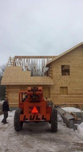 roof being constructed on a log home, beautiful bedroom in log home, Timberhaven Log Homes, log homes, log cabin homes, log cabins, post and beam homes, timberframe homes, timber frame homes, laminated logs, engineered logs, floor plan designs, kiln dried logs, Flury Builders, Joe Walsh, Timberhaven local reps, log homes in Massachusetts, log homes in Rhode Island, MA, RI, log home builders, 2x12 rafter roof system