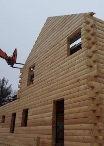 two story log home under construction, windo and door cutouts, builders stacking gable end, solid log gables, Timberhaven Log Homes, log homes, log cabin homes, log cabins, post and beam homes, timberframe homes, timber frame homes, laminated logs, engineered logs, floor plan designs, kiln dried logs, Flury Builders, Joe Walsh, Timberhaven local reps, log homes in Massachusetts, log homes in Rhode Island, MA, RI, log home builders