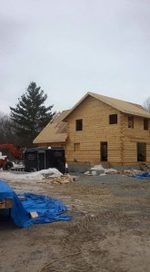 roof being constructed on a log home, beautiful bedroom in log home, Timberhaven Log Homes, log homes, log cabin homes, log cabins, post and beam homes, timberframe homes, timber frame homes, laminated logs, engineered logs, floor plan designs, kiln dried logs, Flury Builders, Joe Walsh, Timberhaven local reps, log homes in Massachusetts, log homes in Rhode Island, MA, RI, log home builders, 2x12 rafter roof system