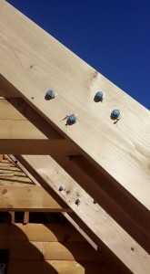 close up of screw placement on rafter and collar ties, 2x12 rafters being installed on custom log home, 2x12 rafter roof, Timberhaven Log Homes, log homes, log cabin homes, log cabins, post and beam homes, timberframe homes, timber frame homes, laminated logs, engineered logs, floor plan designs, kiln dried logs, Flury Builders, Joe Walsh, Timberhaven local reps, log homes in Massachusetts, log homes in Rhode Island, MA, RI, log home builders