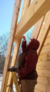 builder installing horizontal collar tie between two rafters, 2x12 rafters being installed on custom log home, 2x12 rafter roof, Timberhaven Log Homes, log homes, log cabin homes, log cabins, post and beam homes, timberframe homes, timber frame homes, laminated logs, engineered logs, floor plan designs, kiln dried logs, Flury Builders, Joe Walsh, Timberhaven local reps, log homes in Massachusetts, log homes in Rhode Island, MA, RI, log home builders