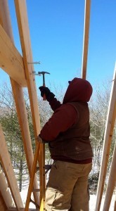 builder installing horizontal collar tie between two rafters, 2x12 rafters being installed on custom log home, 2x12 rafter roof, Timberhaven Log Homes, log homes, log cabin homes, log cabins, post and beam homes, timberframe homes, timber frame homes, laminated logs, engineered logs, floor plan designs, kiln dried logs, Flury Builders, Joe Walsh, Timberhaven local reps, log homes in Massachusetts, log homes in Rhode Island, MA, RI, log home builders