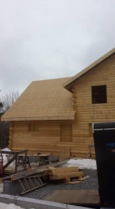 roof being constructed on a log home, beautiful bedroom in log home, Timberhaven Log Homes, log homes, log cabin homes, log cabins, post and beam homes, timberframe homes, timber frame homes, laminated logs, engineered logs, floor plan designs, kiln dried logs, Flury Builders, Joe Walsh, Timberhaven local reps, log homes in Massachusetts, log homes in Rhode Island, MA, RI, log home builders, 2x12 rafter roof system