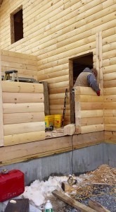 builder stacking logs for breezeway, solid log breezeway, Log Homes, log homes, log cabin homes, log cabins, post and beam homes, timberframe homes, timber frame homes, laminated logs, engineered logs, floor plan designs, kiln dried logs, Flury Builders, Joe Walsh, Timberhaven local reps, log homes in Massachusetts, log homes in Rhode Island, MA, RI, log home builders, solid log breezeway