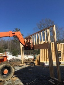 lift hoisting front garage wall with header into place, two-car garage, Timberhaven Log Homes, log homes, log cabin homes, log cabins, post and beam homes, timberframe homes, timber frame homes, laminated logs, engineered logs, floor plan designs, kiln dried logs, Flury Builders, Joe Walsh, Timberhaven local reps, log homes in Massachusetts, log homes in Rhode Island, MA, RI, log home builders