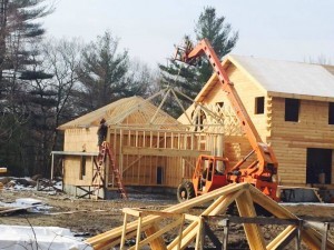 pre-fab trusses being placed on stick framed garage, two-car garage, Timberhaven Log Homes, log homes, log cabin homes, log cabins, post and beam homes, timberframe homes, timber frame homes, laminated logs, engineered logs, floor plan designs, kiln dried logs, Flury Builders, Joe Walsh, Timberhaven local reps, log homes in Massachusetts, log homes in Rhode Island, MA, RI, log home builders