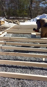 builder assembling stick-frame garage wall on the ground, two-car garage, Timberhaven Log Homes, log homes, log cabin homes, log cabins, post and beam homes, timberframe homes, timber frame homes, laminated logs, engineered logs, floor plan designs, kiln dried logs, Flury Builders, Joe Walsh, Timberhaven local reps, log homes in Massachusetts, log homes in Rhode Island, MA, RI, log home builders