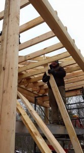 building shed porch on log home, outdoor living area, Timberhaven Log Homes, log homes, log cabin homes, log cabins, post and beam homes, timberframe homes, timber frame homes, laminated logs, engineered logs, floor plan designs, kiln dried logs, Flury Builders, Joe Walsh, Timberhaven local reps, log homes in Massachusetts, log homes in Rhode Island, MA, RI, log home builders