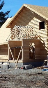 trusses in place forming roof for breezeway, solid log breezeway, Timberhaven Log Homes, log homes, log cabin homes, log cabins, post and beam homes, timberframe homes, timber frame homes, laminated logs, engineered logs, floor plan designs, kiln dried logs, Flury Builders, Joe Walsh, Timberhaven local reps, log homes in Massachusetts, log homes in Rhode Island, MA, RI, log home builders