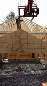 sheathing for gable end of two car garage being lifted into place, two-car garage, Timberhaven Log Homes, log homes, log cabin homes, log cabins, post and beam homes, timberframe homes, timber frame homes, laminated logs, engineered logs, floor plan designs, kiln dried logs, Flury Builders, Joe Walsh, Timberhaven local reps, log homes in Massachusetts, log homes in Rhode Island, MA, RI, log home builders