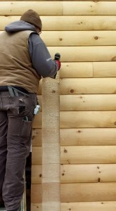 builder chiseling out log way for post, solid log breezeway, Log Homes, log homes, log cabin homes, log cabins, post and beam homes, timberframe homes, timber frame homes, laminated logs, engineered logs, floor plan designs, kiln dried logs, Flury Builders, Joe Walsh, Timberhaven local reps, log homes in Massachusetts, log homes in Rhode Island, MA, RI, log home builders, solid log breezeway