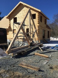 constructing King Post Truss, outdoor living area, Timberhaven Log Homes, log homes, log cabin homes, log cabins, post and beam homes, timberframe homes, timber frame homes, laminated logs, engineered logs, floor plan designs, kiln dried logs, Flury Builders, Joe Walsh, Timberhaven local reps, log homes in Massachusetts, log homes in Rhode Island, MA, RI, log home builders