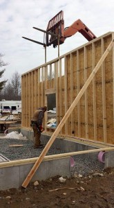 conventional garage wall being braced by stem wall, two-car garage, Timberhaven Log Homes, log homes, log cabin homes, log cabins, post and beam homes, timberframe homes, timber frame homes, laminated logs, engineered logs, floor plan designs, kiln dried logs, Flury Builders, Joe Walsh, Timberhaven local reps, log homes in Massachusetts, log homes in Rhode Island, MA, RI, log home builders