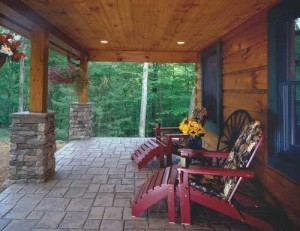 beautiful outdoor living area of log home with stone colums, Timberhaven Log Homes, log homes, log cabin homes, log cabins, post and beam homes, timberframe homes, timber frame homes, laminated logs, engineered logs, floor plan designs, kiln dried logs, Flury Builders, Joe Walsh, Timberhaven local reps, log homes in Massachusetts, log homes in Rhode Island, MA, RI, log home builders